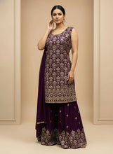 Load image into Gallery viewer, Woman wearing a purple embroidered traditional outfit with a matching dupatta on a beige background