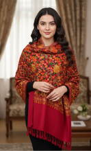 Load image into Gallery viewer, Woman wearing a red and orange patterned scarf in a room with furniture and decor.