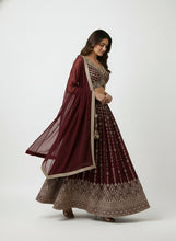 Load image into Gallery viewer, Woman wearing a maroon and gold traditional outfit on a white background