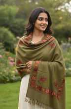 Load image into Gallery viewer, Woman wearing a green embroidered shawl in a garden setting
