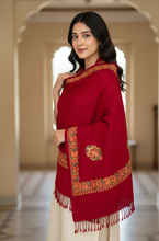 Load image into Gallery viewer, Woman wearing a red embroidered shawl in an elegant interior setting
