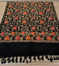 Load image into Gallery viewer, Black fabric with intricate floral embroidery on a wooden surface
