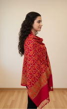 Load image into Gallery viewer, Woman wearing a red patterned shawl against a plain background
