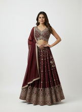 Load image into Gallery viewer, Woman wearing a traditional navy blue and silver lehenga on a beige background

