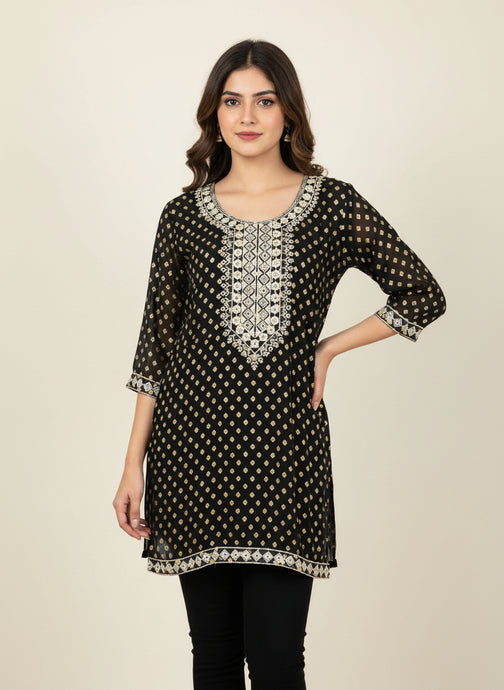 Black and gold patterned top with lace details on a yellow background