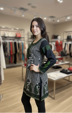 Load image into Gallery viewer, Woman wearing a patterned dress in a clothing store
